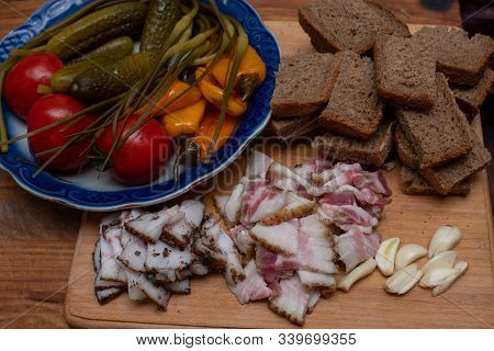 Bacon, Bread And Cucumber Over Wooden Background. Russian And Ukrainian Traditional Appetizer, Black