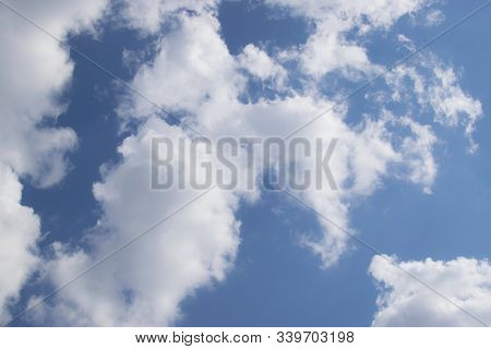 Large Fluffy Clouds Against A Blue Sky. Sunny Weather, Summer. Bright Blue Sky Sunny Day. Сottony Cl