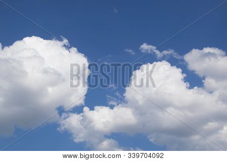 Fantastic Panorama View Of Bright White Puffy Cottony Clouds Lit By Sun Spreading Against Deep Blue 