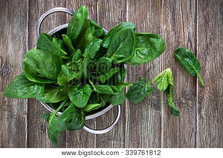 Fresh Spinach Leaves In A Bowl On A Wooden Table. Useful, Tasty, Low-calorie Greens. Young Spinach S
