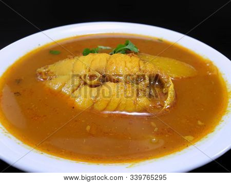 Thai Food Style,top View Sour Soup With Snapper And Young Coconut Shoots In White Bowl As A Backgrou