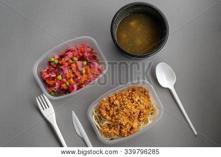 Pasta With Minced Meat And Onion In Navy-style And A Jar Of Vinaigrette On A Gray Background. Food F
