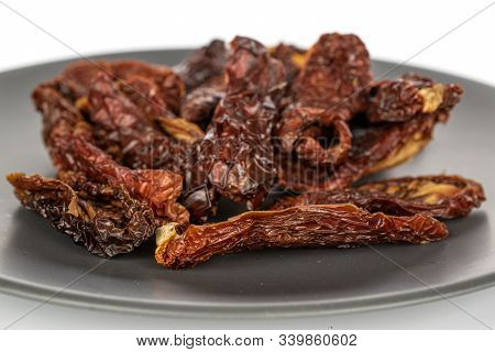 Lot Of Whole Dried Red Tomato Piece On Gray Ceramic Plate Isolated On White Background