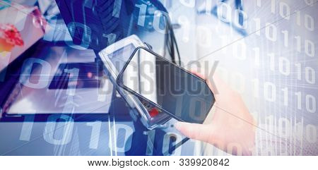 Binary code on blue circuit board against cropped image person making mobile payment 