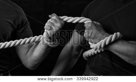 Tug Of War. The Concept Of Strength And Struggle. Two Men Are Fighting For Leadership In Tug Of War.
