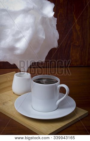 Cotton Candy And Cup Of Coffee On A Wooden Table