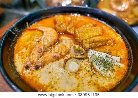 SINGAPORE - CIRCA APRIL, 2019: close up shot of Seafood Laksa served at Shoppes at Marina Bay Sands. Laksa is a spicy noodle soup popular in the Peranakan cuisine of Southeast Asia