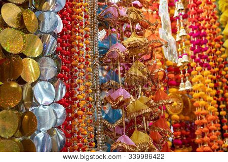 Colorful Hanging Decorations On Display For Sale In Chandi Chowk Old Delhi. These Flowers, Beads And