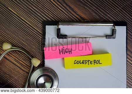 High Colesterol Write On Sticky Notes Isolated On Wooden Table.