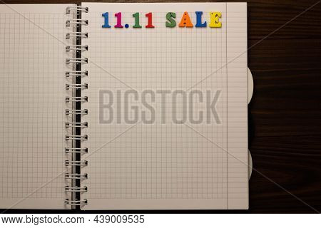 11.11 Sale Concept. Multicolored Colorful Letters In A Squared Exercise Book On The Table With Copy 