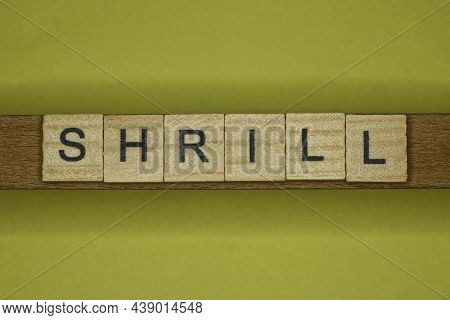 Word Shrill Made From Wooden Letters Lies On A Yellow Table