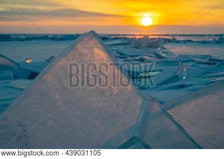 Beautiful Landscape Of Uzury Bay With Ice Hummock Rising Above The Frozen Lake Of Baikal At Sunrise.