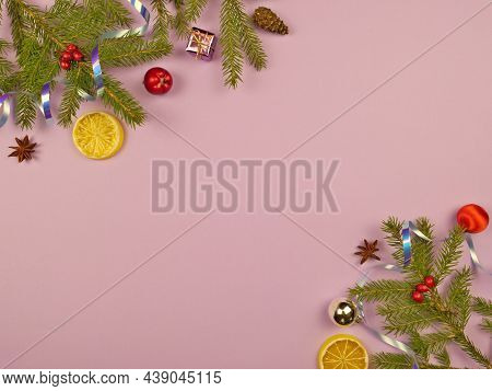 Christmas Background. Branches Of A Christmas Tree And Christmas Tree Toys On A Pink Background. New