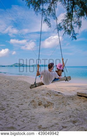 Bang Tao Beach Phuket Thailand, Beach With Palm Trees And A Couple Man And Women In The Swing On The