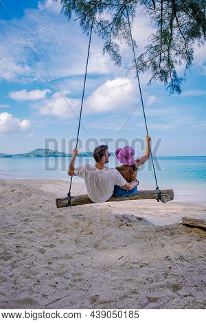 Bang Tao Beach Phuket Thailand, Beach With Palm Trees And A Couple Man And Women In The Swing On The