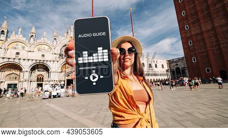 Audio Tour Online App On Digital Mobile Smartphone. Happy Young Student Woman Holding Phone Listenin