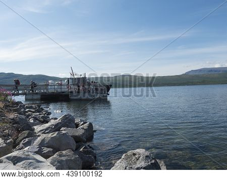 Vakkotavare, Norrbotten, Sweden, Agust 7, 2021: Group Of Hikers And Tourist Getting Off Ferry Boat S