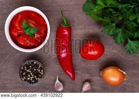 Top View Of Lecho Of Tomatoes And Sweet Paprika With Ingredients On The Table. Lecso National Dish O