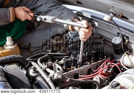 The Mechanic Uses A Torque Dynamometer Wrench To Install The Cylinder Head At Old Engine. Disassembl