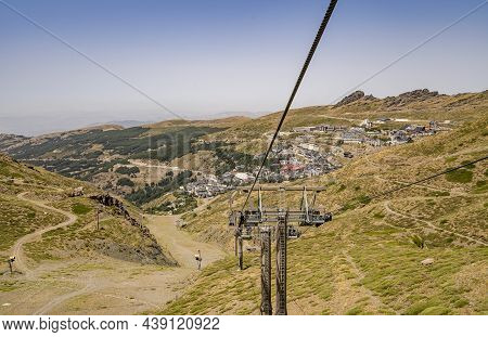 Sierra Nevada Village With Cable Car Going Up Into The Mountains, Spain