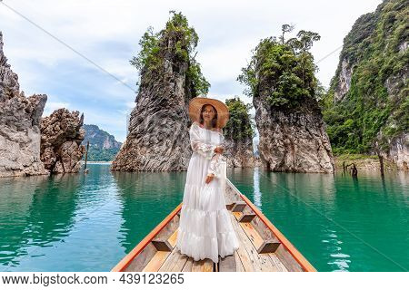 Happy Young Female Tourist In Dress And Hat At Longtail Boat Near Famous Three Rocks With Limestone 