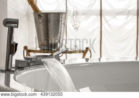 Spout Running Water From Wide Bath Tube Faucet Into A Hot  Bath With Ice Bucket And Champagne Glass 