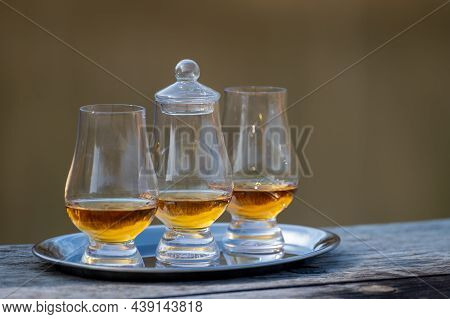 Tasting Glasses Of Scotch Whisky Strong Drink On Old Outdoor Wooden Table