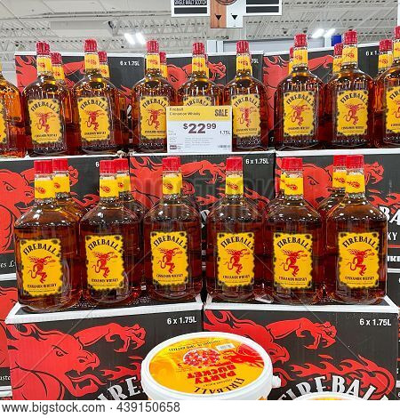 A Display Of Bottles Of Fireball Cinnamon Whisky  With Background Bokeh At A Binneys Liqour Store In