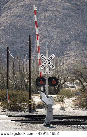 A Railroad Crossing Barracade In The Desert.