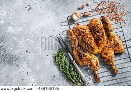 Traditional Spatchcocked Barbecue Chicken On Grill. Gray Background. Top View. Copy Space