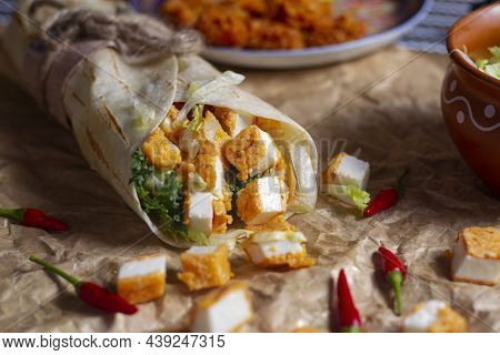 Fresh Paneer Roll With Fresh Tomatos, Salad, Cheese And Onions Isolated On Bright Blue Background. S