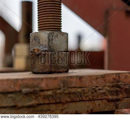 The Nut Is Screwed Onto The Bolt. Fastening A Large Bridge. Bolt And Nut.