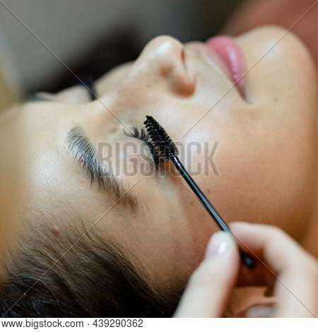 Customer getting eyelash treatment at a beauty salon