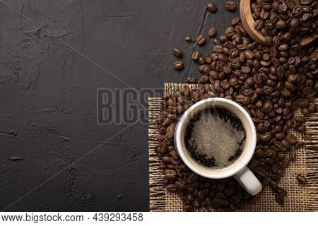 White Lungo Cup With Hot Coffee Drink And Toasted Coffee Beans Scattered On A Rustic Black Table. To