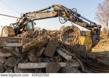 Photo Of A Yellow Excavator With A Bucket Trying To Lift More Than Its Own Weight