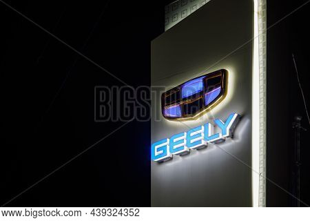Geely Logo On Car Dealership Pillar At Foggy Night - Geely Is One Of The Largest Chinese Automobile 