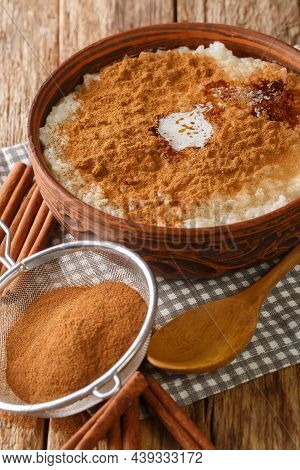 Danish Rice Pudding Also Known As Risengrod With Sugar, Butter And Cinnamon Close Up In The Bowl On 