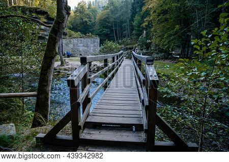 Bohemian Switzerland National Park, Czech Republic, 2 October 2021:  Old Wooden Bridge Over River Ka