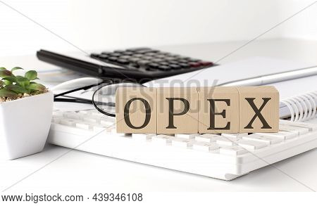 Opex Written On A Wooden Cube On The Keyboard With Office Tools