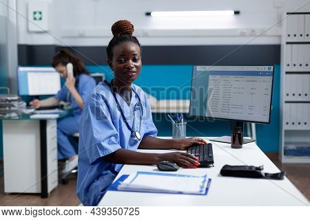 Portrait Of African American Pharmacist Nurse Typing Medical Prescription Checking Pharmaceutical Me