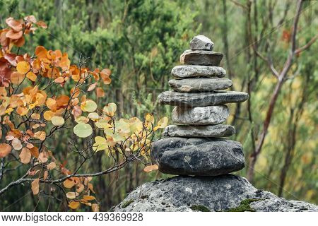 Balance stones on the rock in autumn forest. Concept of balance and harmony