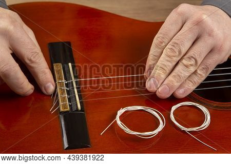 Replacement And Insertion Of Nylon Strings In A Classical Guitar. Lesson For A Musician