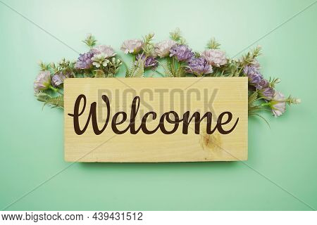 Welcome Sign With Flowers Frame Decprate On Green Background