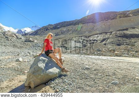 Girl With Red Swiss Flag T-shirt Sitting After Trekking To Morteratsch Glacier In Switzerland. Berni