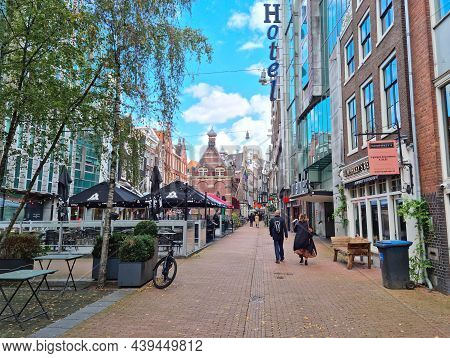Amsterdam, The Netherlands - 04 October, 2021: People Walking In The Nieuwezijds Voorburgwal Street.