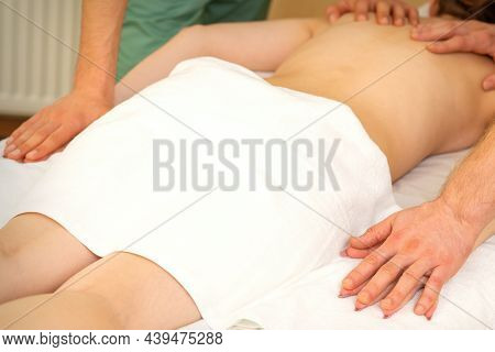 Back And Hands Double Massage With Four Hands Of Two Professional Massagers For A Young Caucasian Wo