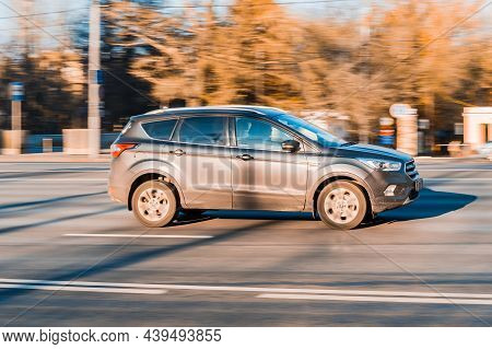 Suv Car In Motion. Ford Escape Third Generation Moving On The Street. Gray Ford Kuga Is Driving On U