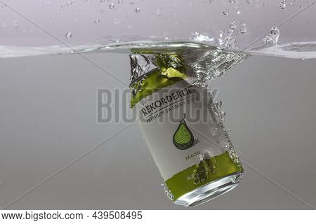 Close Up View Of Can Of Pear Sider Falling Into Water Isolation On Background. Sweden. Uppsala. 11.1