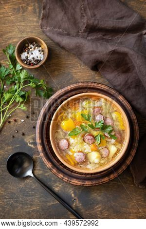 Czech Food: Traditional Zelnacka Cabbage Soup With Sausages And Vegetables In A Bowl On Rustic Woode