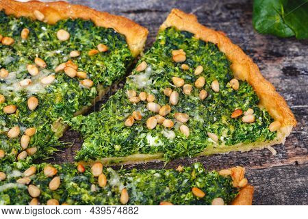 Tart With Spinach, Ricotta Cheese And Pine Nuts On Wooden Rustic Table. Close Up